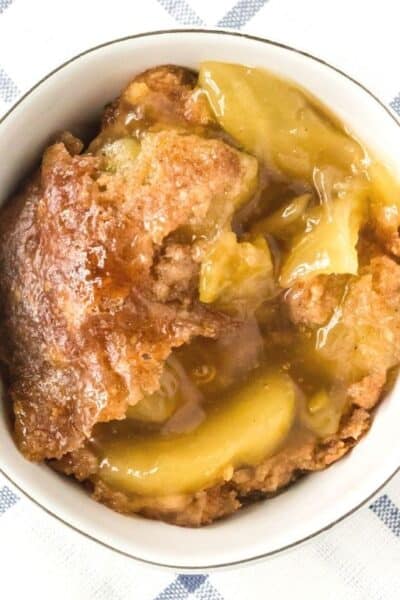 overhead view of a white bowl with a helping of Instant Pot apple dump cake in it