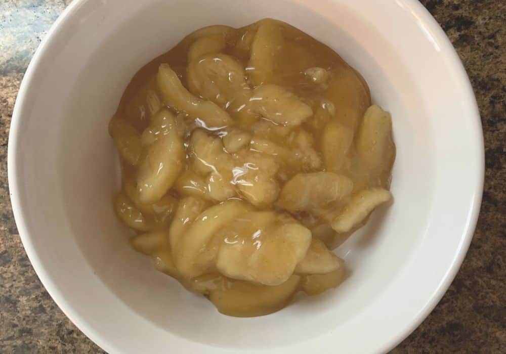 apple pie filling spread in a corningware 1.5-quart dish