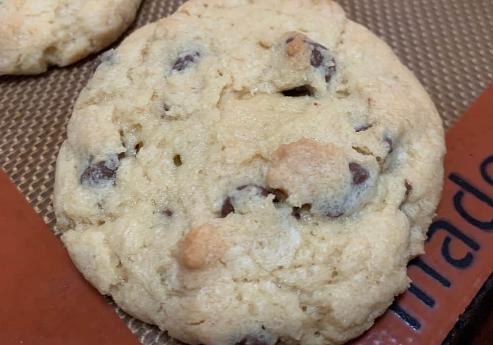 close-up view of a freshly baked chocolate chip cookie (with no brown sugar), showing the degree to which it should be baked before removing from oven.