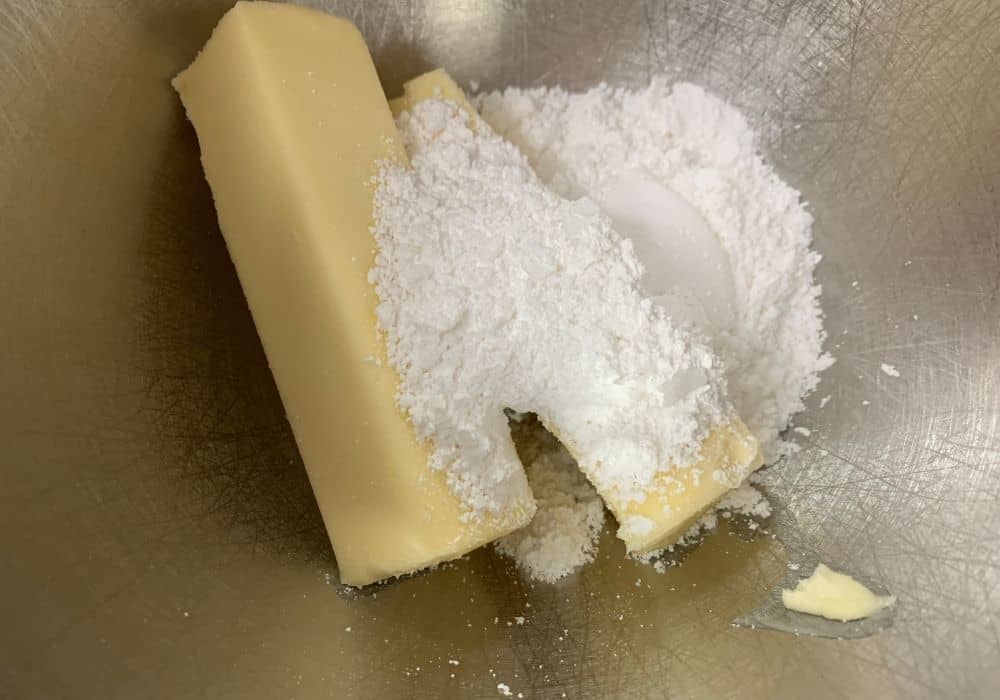 butter and powdered sugar in a mixing bowl