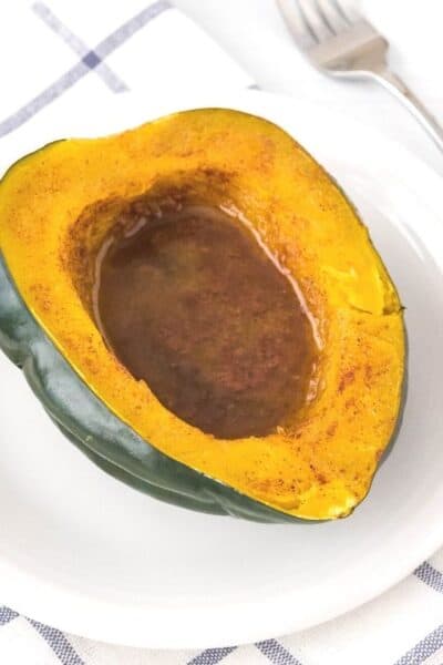 Instant Pot acorn squash topped with butter, brown sugar, cinnamon, and nutmeg.