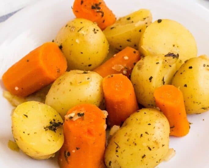 serving of Instant Pot potatoes and carrots on a white plate for serving