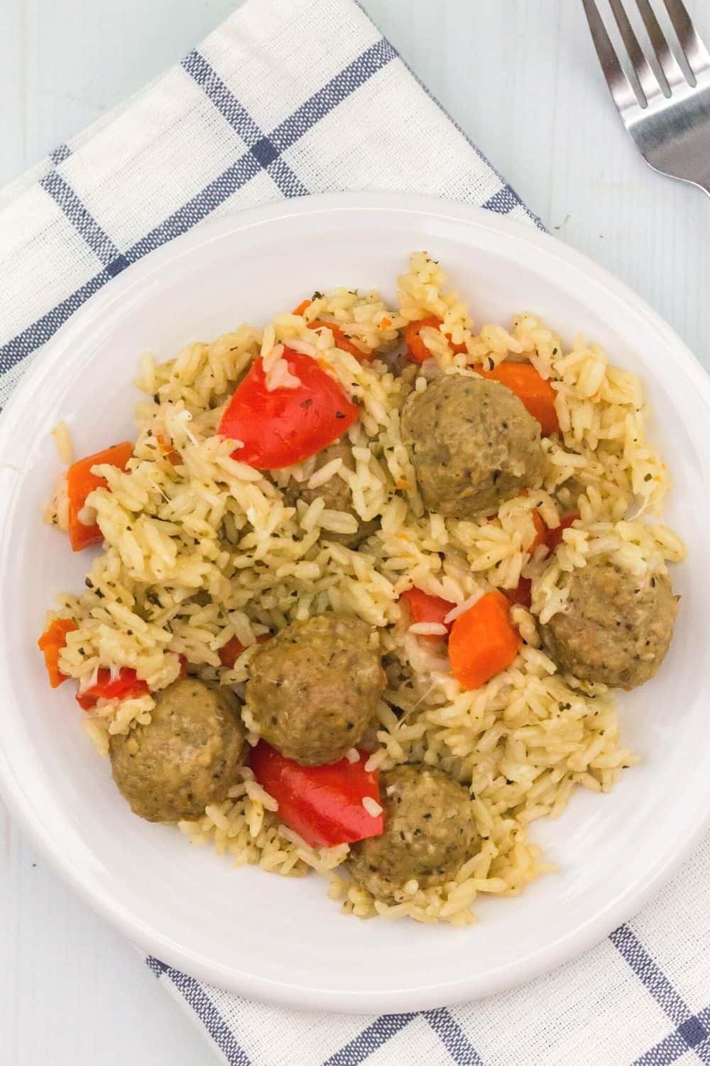 overhead view of a plate of cheesy Instant Pot meatballs and rice