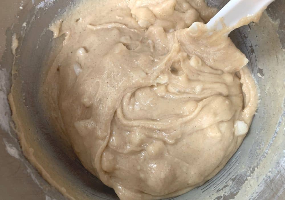 pear cake batter in the bowl of a stand mixer