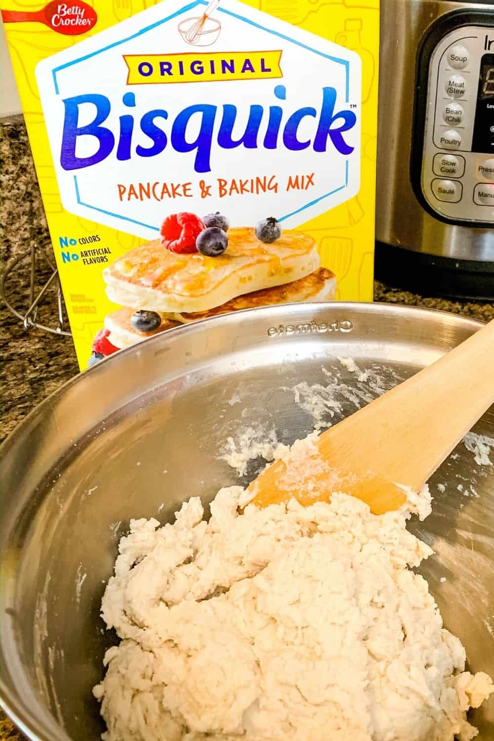mixing bowl of bisquick dumpling dough with a box of baking mix in the background