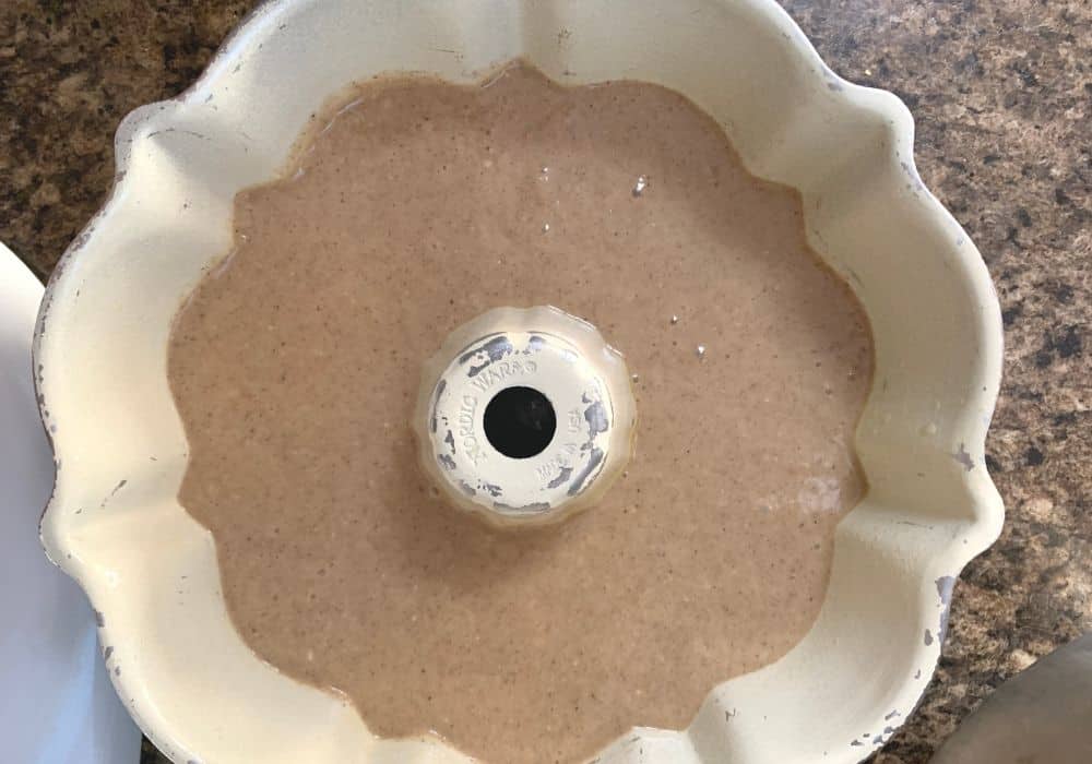 spice cake batter poured into the prepared bundt pan