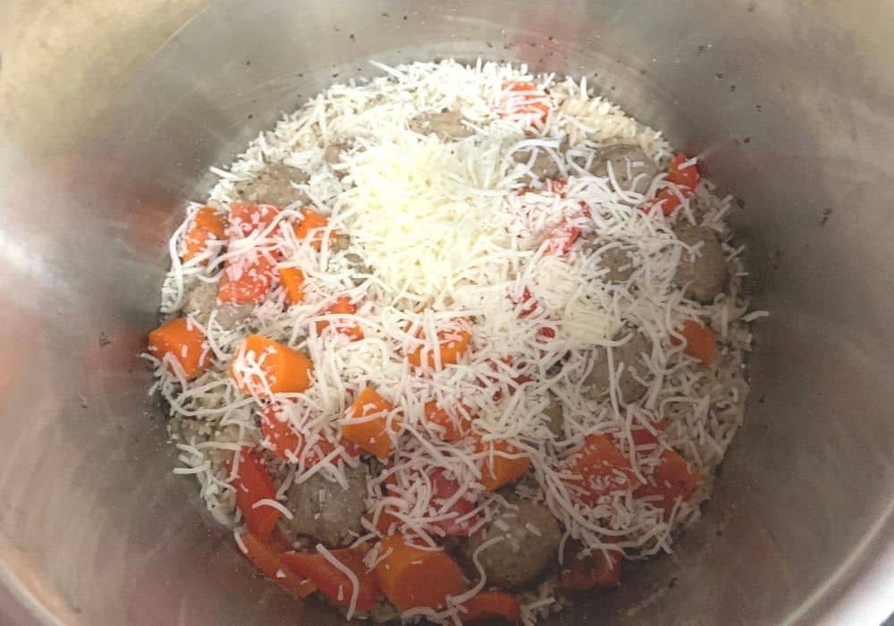 shredded mozzarella cheese sprinkled over the meatballs and rice, prior to stirring