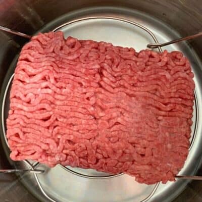 raw, frozen ground beef in the Instant Pot, ready for cooking