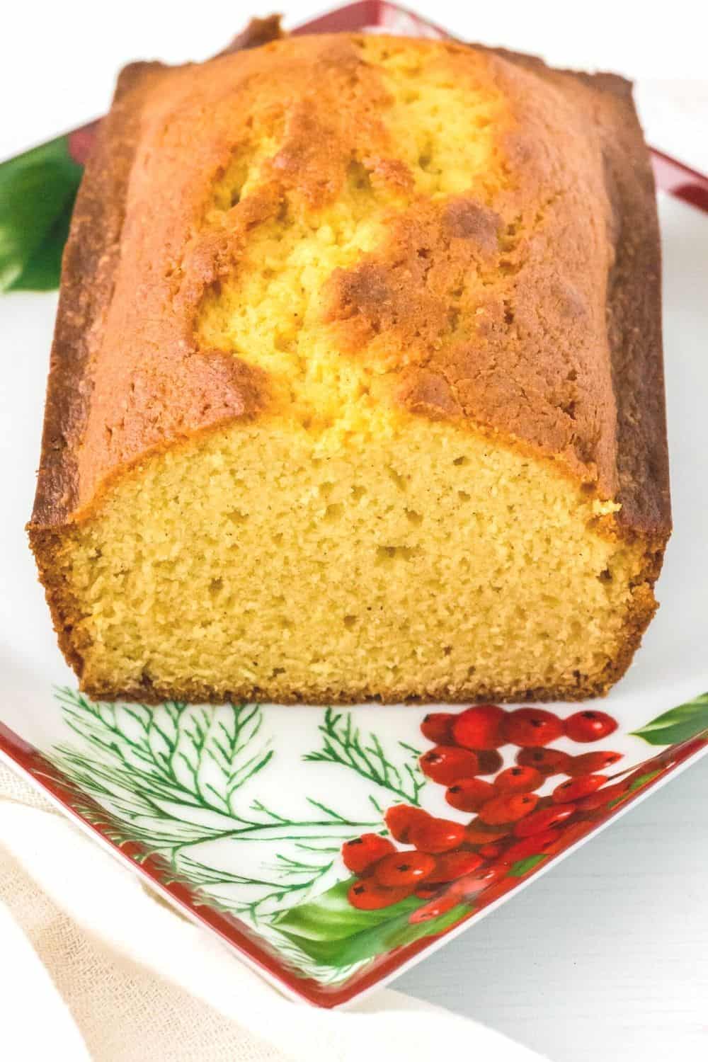 partially sliced eggnog loaf cake on a christmas plate