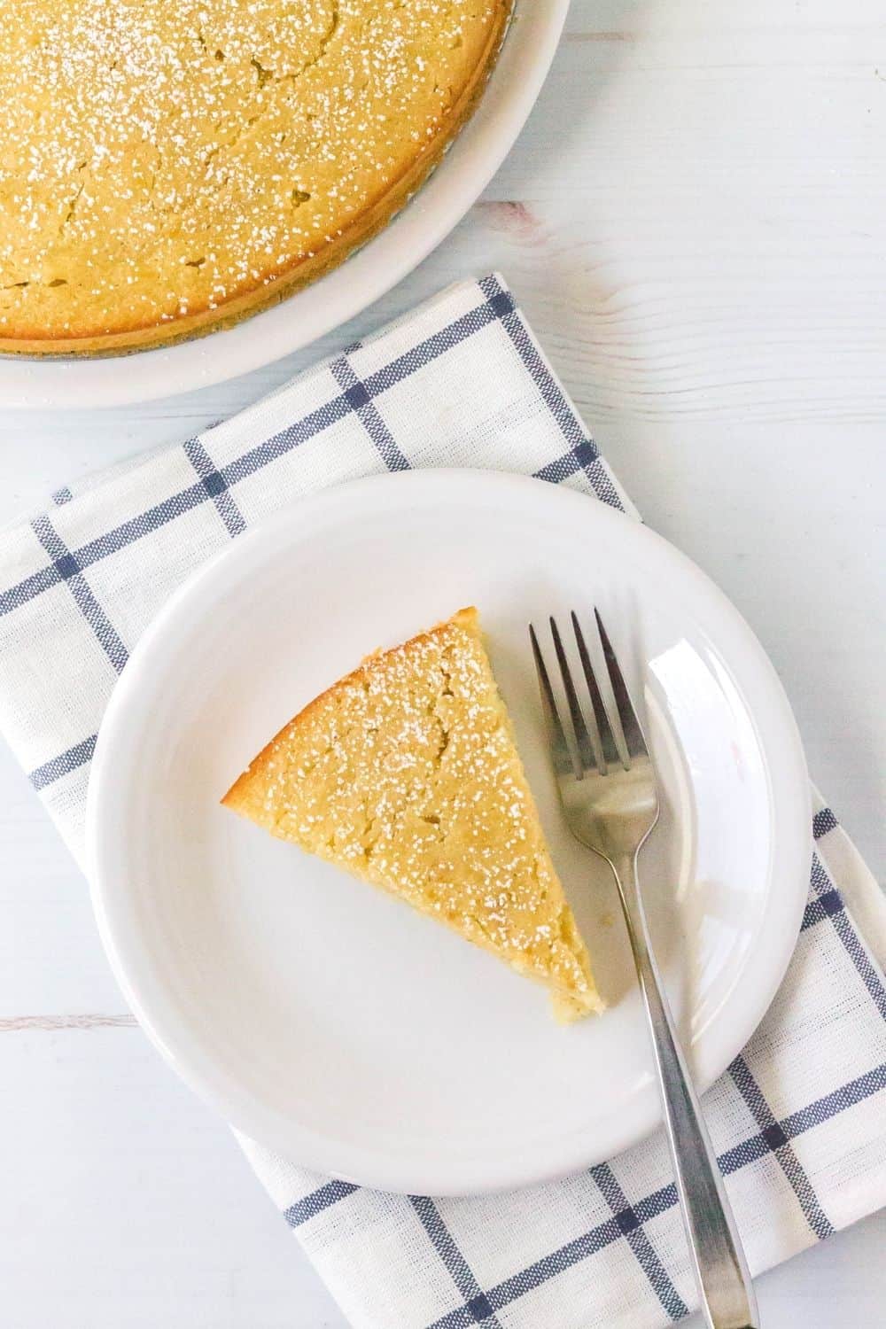 slice of pureed pear cake on a white plate with a fork next to it