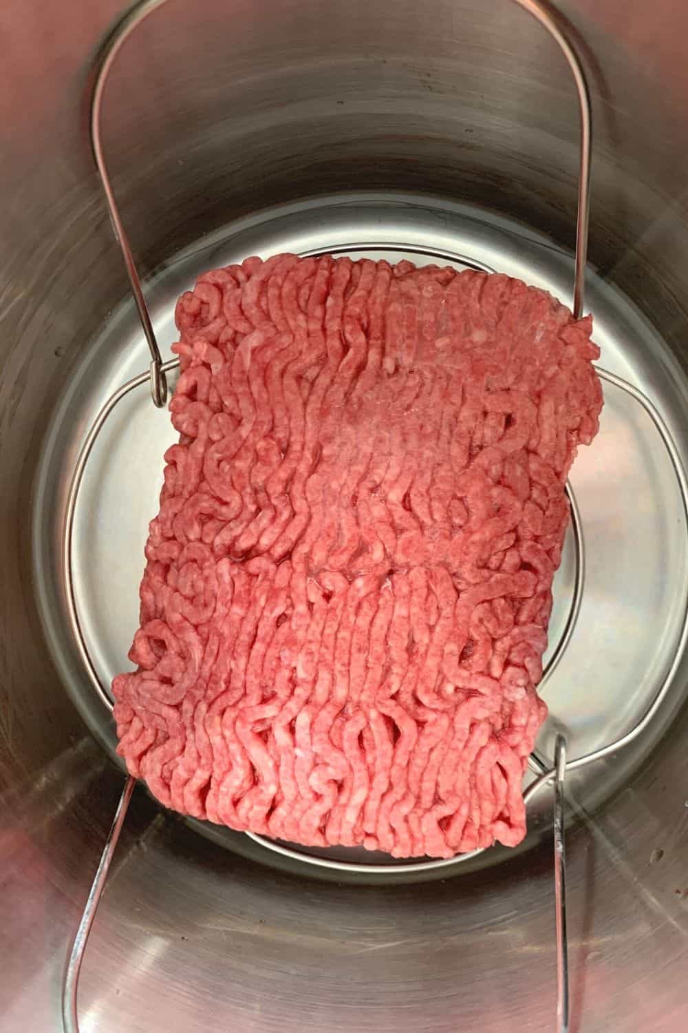 frozen ground beef on the trivet in the Instant Pot pressure cooker