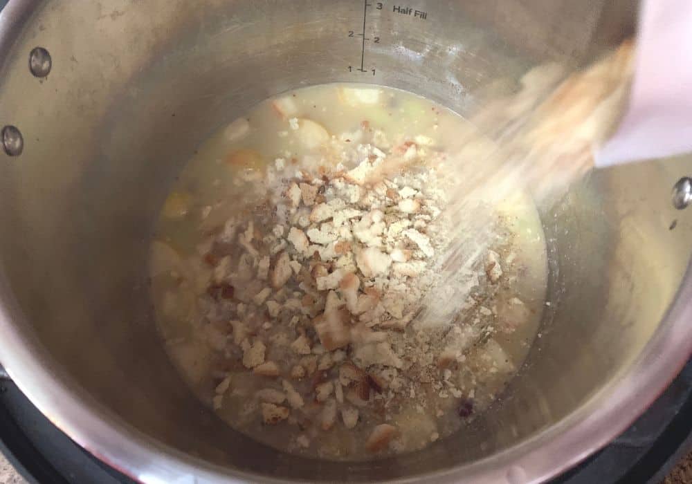 dry stuffing mix being poured into the instant pot