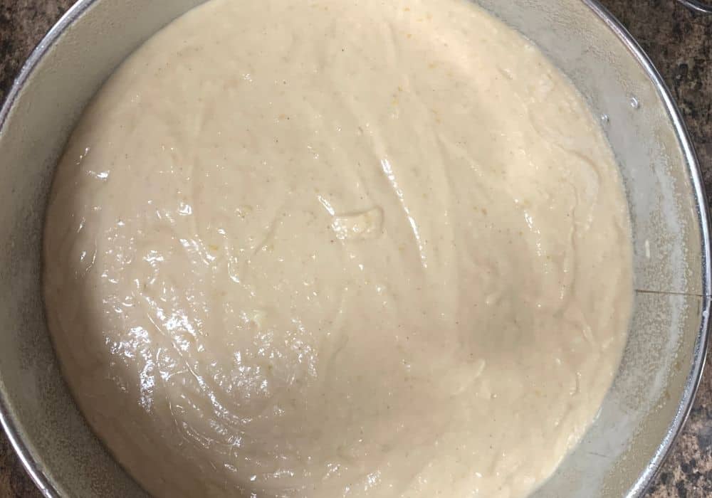 pear cake batter in prepared springform pan, ready for baking