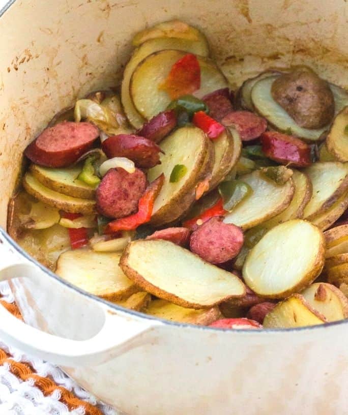 smoked sausage, potatoes, peppers, and onions in a dutch oven