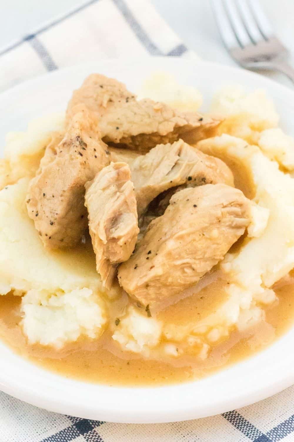 pork chops served over mashed potatoes and drizzled with gravy