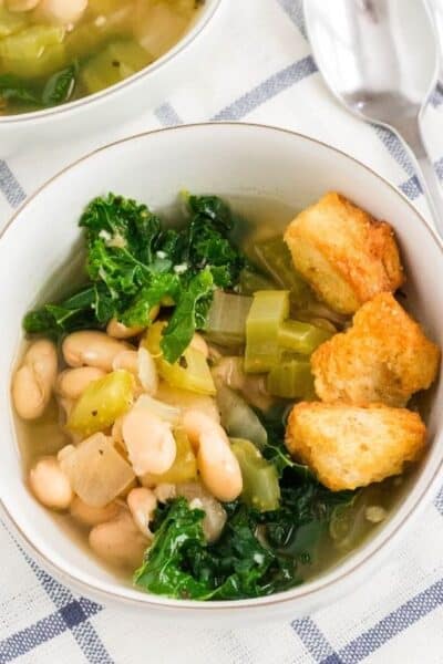 white bowl of Instant Pot kale and white bean soup