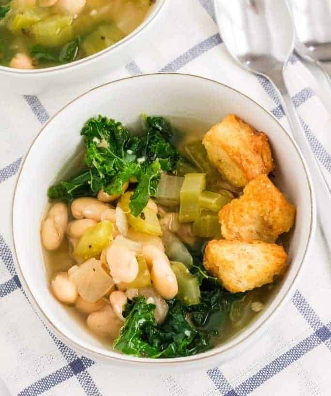 white bowl of Instant Pot kale and white bean soup