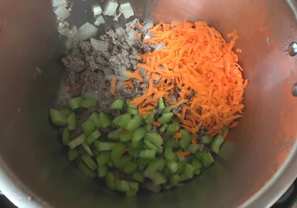 shredded carrots and diced celery added to the browned ground beef and onions in the Instant Pot