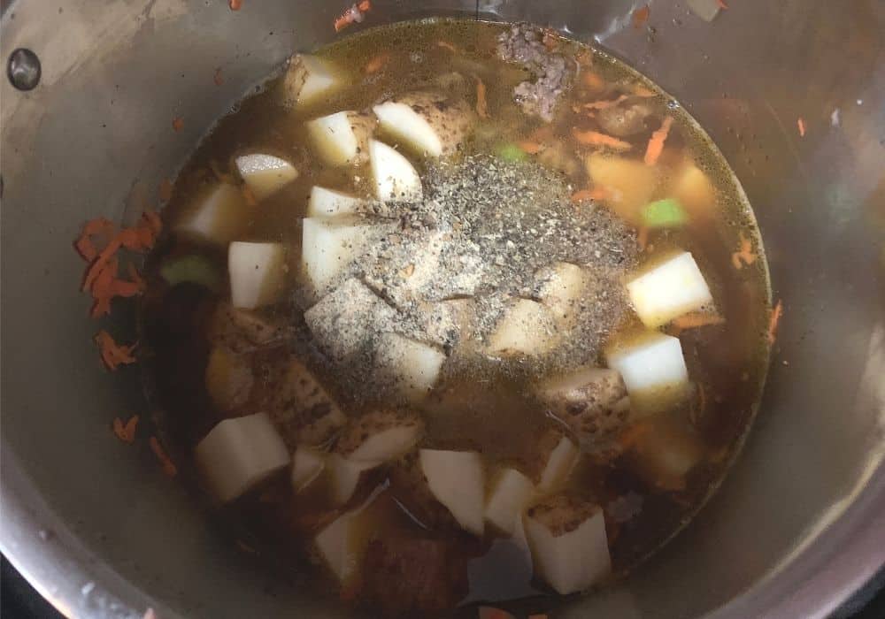 broth, potatoes, and seasonings added to the Instant Pot