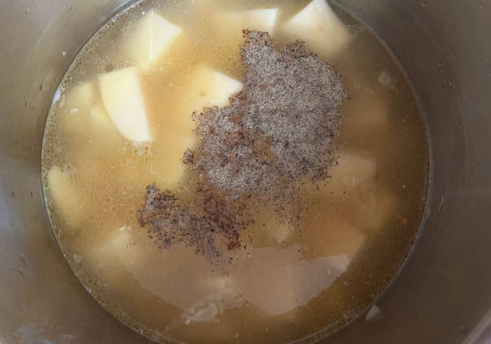 potatoes, broth, and seasonings added to the insert pot of the Instant Pot
