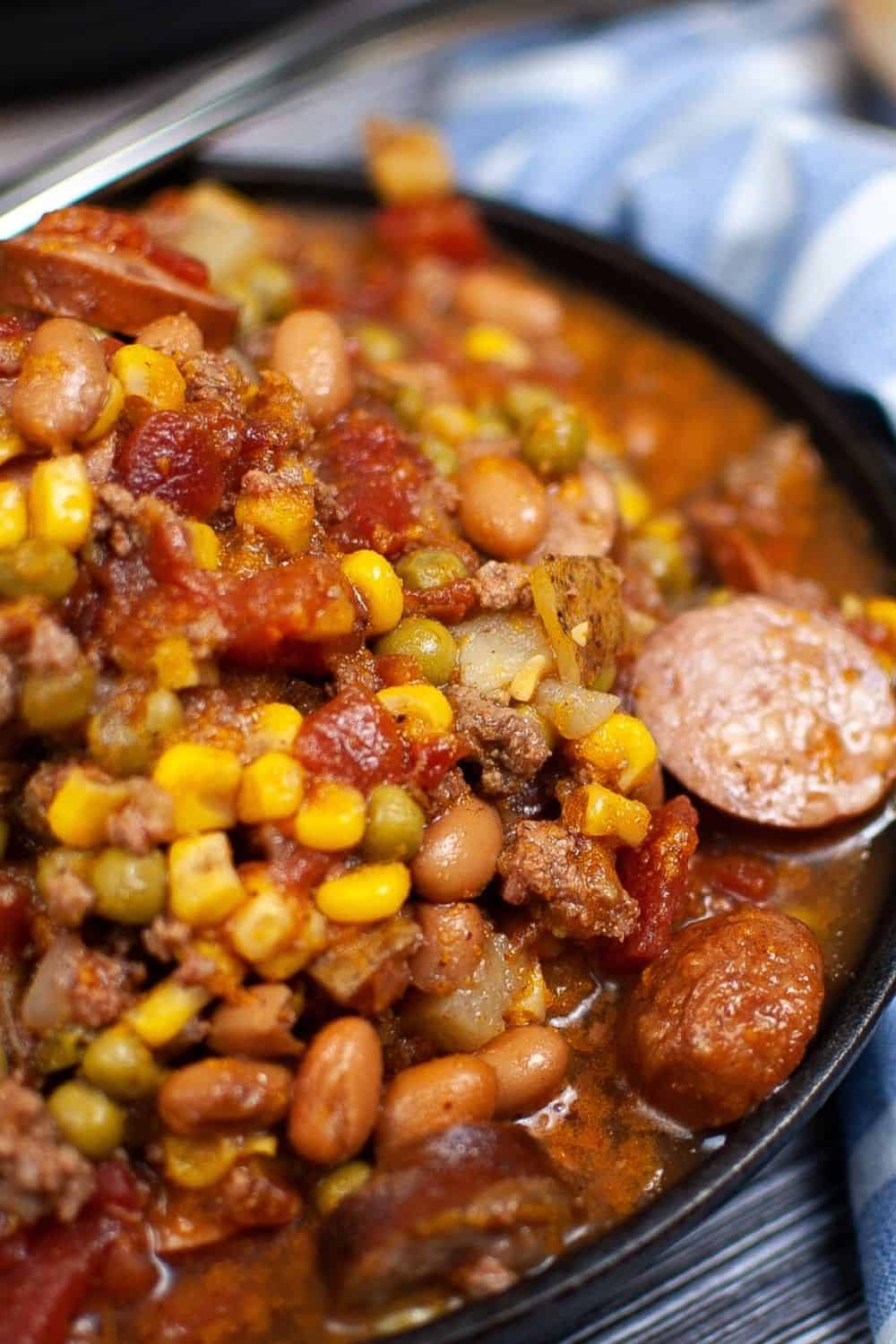 close-up view of the corn, peas, beans, tomatoes, kielbasa, potatoes, and ground beef that make up the cowboy stew.