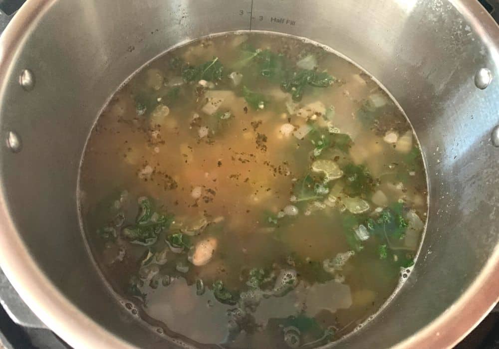 kale added tot he white bean soup in the insert pot of the Instant Pot after pressure cooking.