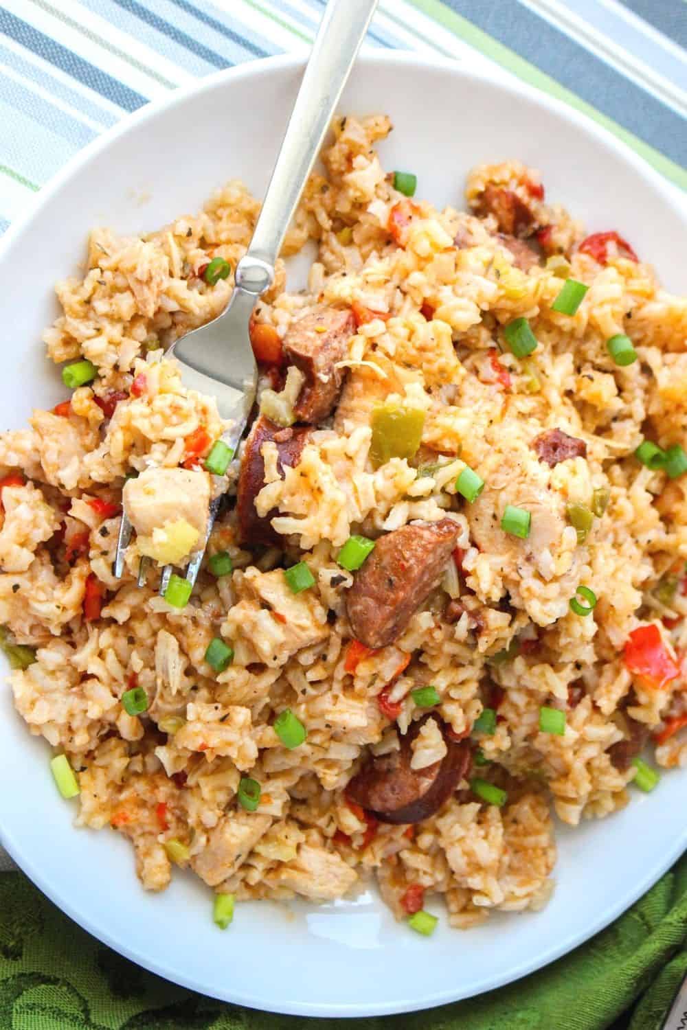 Instant Pot jambalaya made with chicken and sausage, served on a white plate with a fork in it