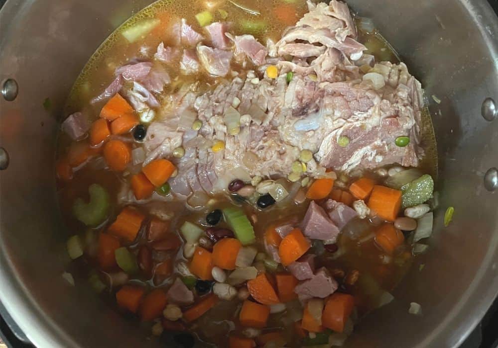 hambone, veggies, broth, beans added to the insert pot of the Instant Pot