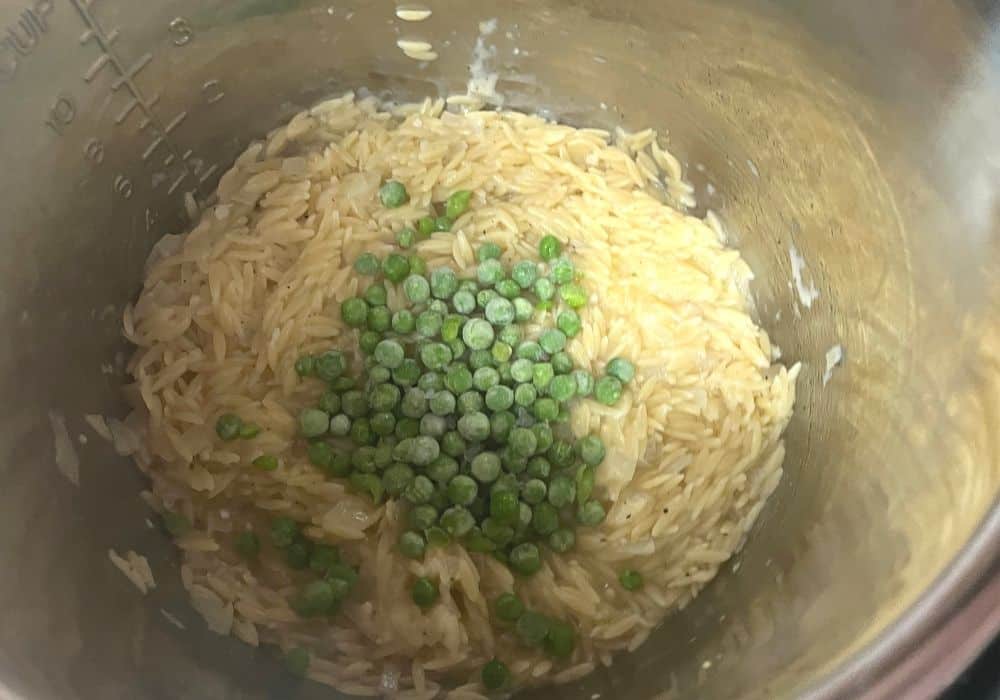 lemon juice and frozen peas added to the cooked orzo in the instant pot