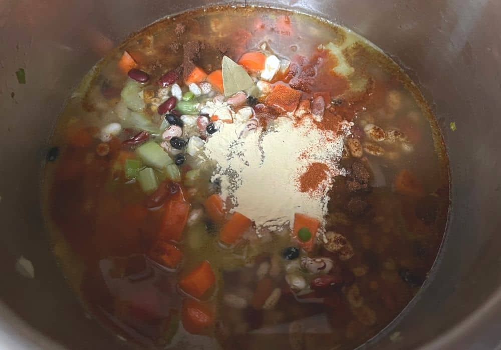 seasonings added to beans and broth and veggies in the instant pot