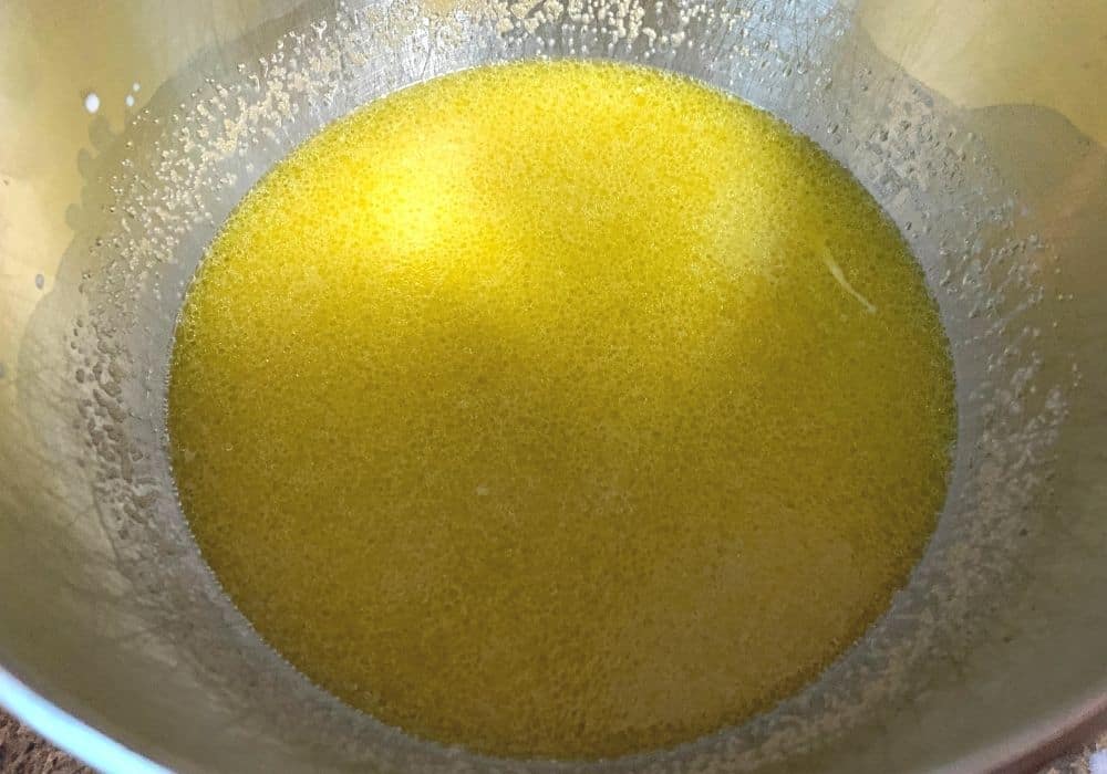 milk, olive oil, eggs, and yeast combined in a mixing bowl