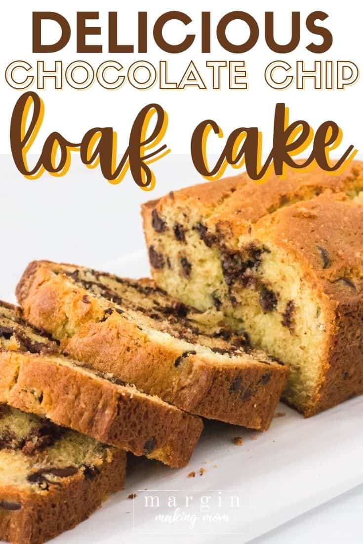 an angled view of a sliced chocolate chip loaf cake on a white plate