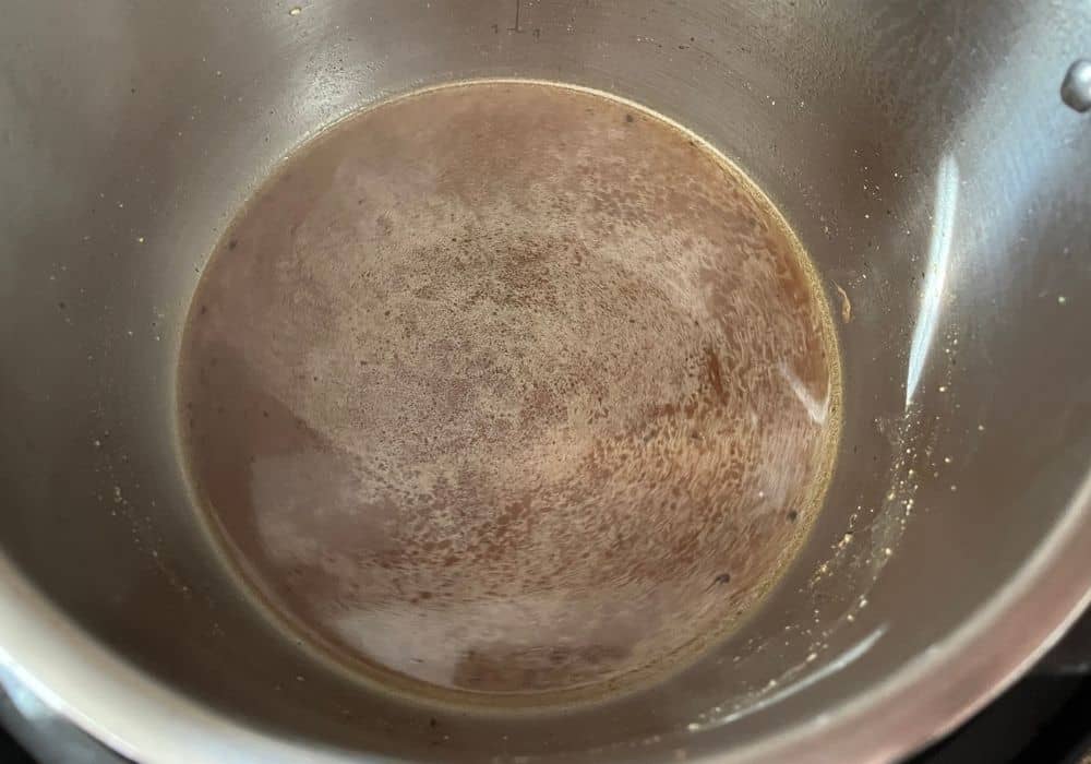 Chicken broth and Worcestershire sauce in the Instant Pot for cooking pork chops