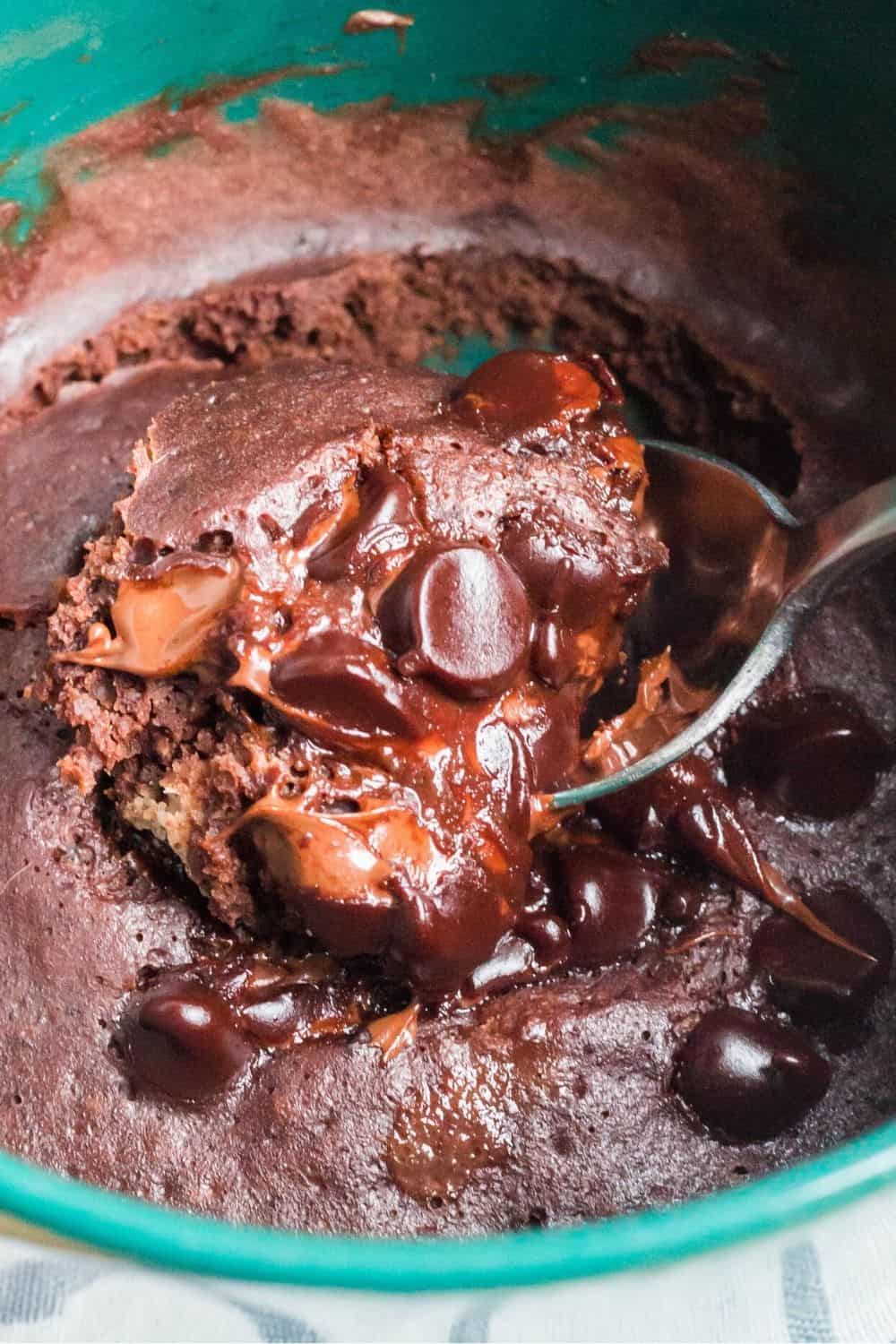 a spoon removes a bite of chocolate mug cake that was cooked without a microwave, using the Instant Pot