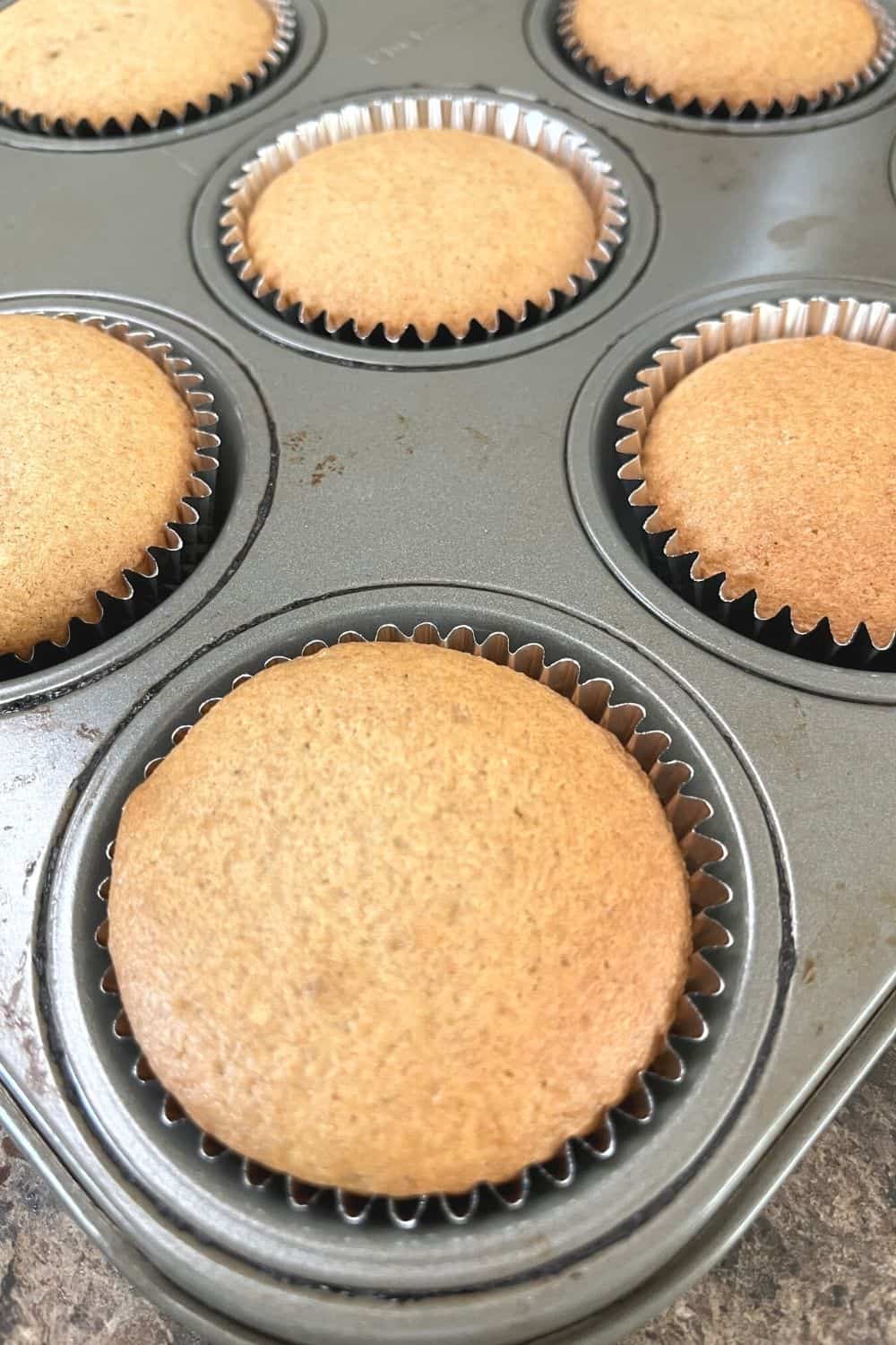 freshly baked churro cupcakes before being frosted