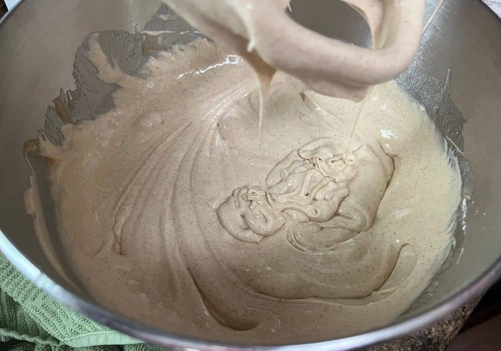 churro cupcake batter made from a cake mix, in the bowl of a stand mixer