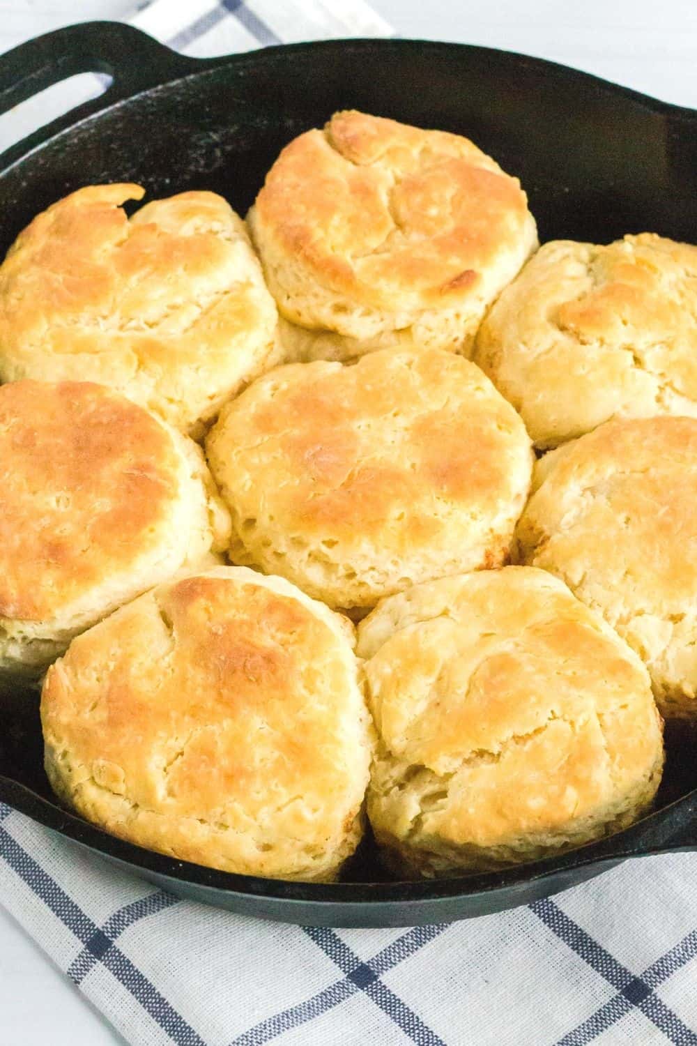 close-up view of golden-brown southern biscuits made with sour cream, freshly baked in a cast iron skillet