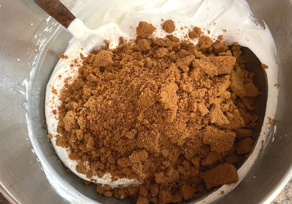 chopped and crushed Biscoff speculoos cookies added to the sweet cream base for making homemade ice cream