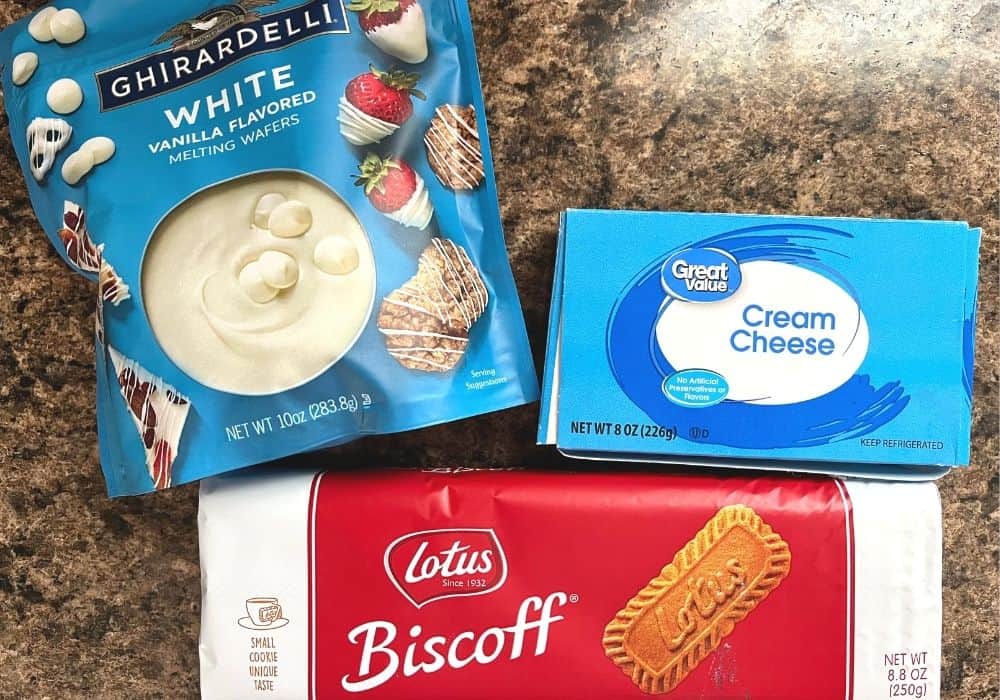 packages of ingredients needed for biscoff truffles, including ghirardelli white chocolate, cream cheese, and Lotus biscoff cookies.