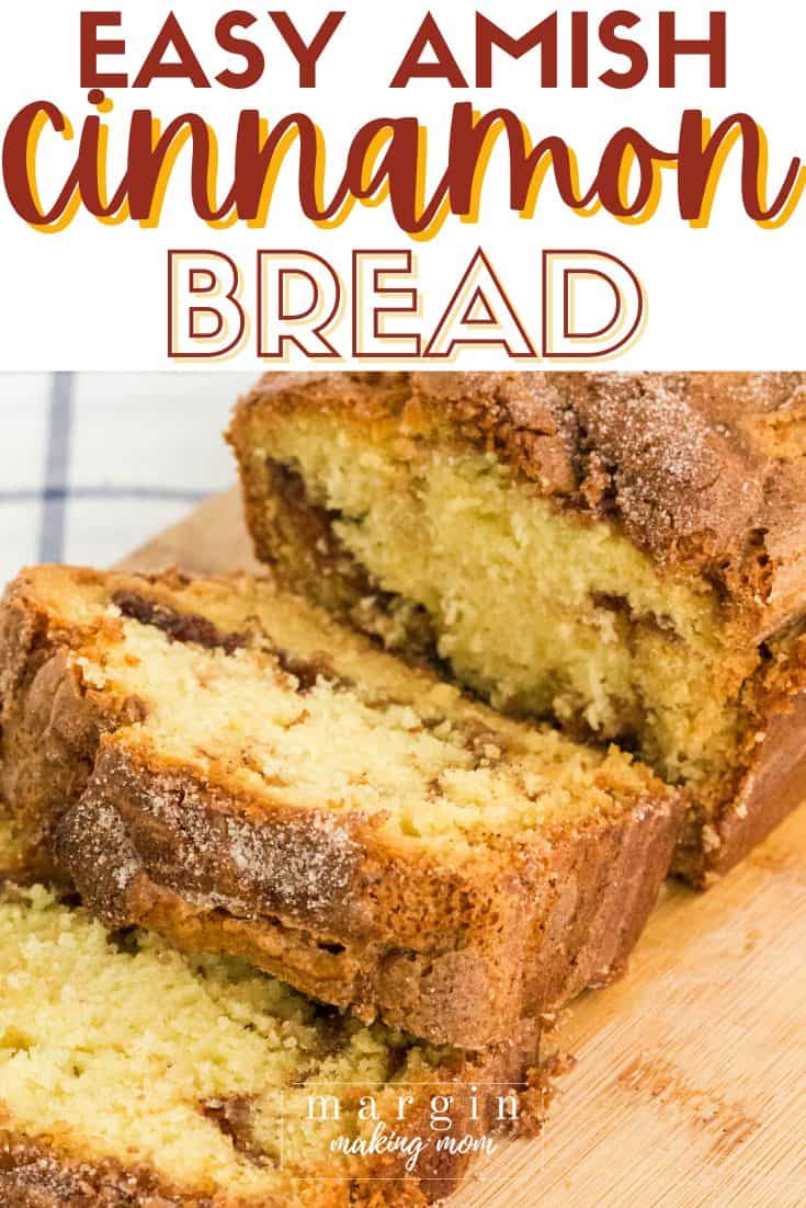 a sliced loaf of Amish cinnamon bread on a wooden cutting board.