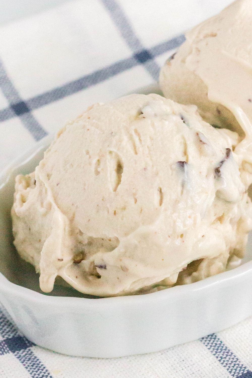 white dish with two scoops of copycat chunky monkey banana ice cream in it