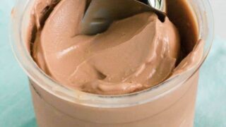 a pint of Ninja Creami chocolate ice cream with a scoop in it