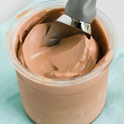 a pint of Ninja Creami chocolate ice cream with a scoop in it