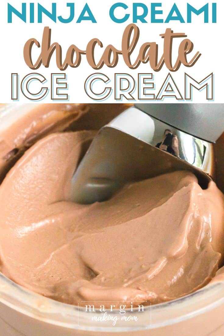 close-up view of a pint of Ninja Creami chocolate ice cream with an ice cream scoop in it.
