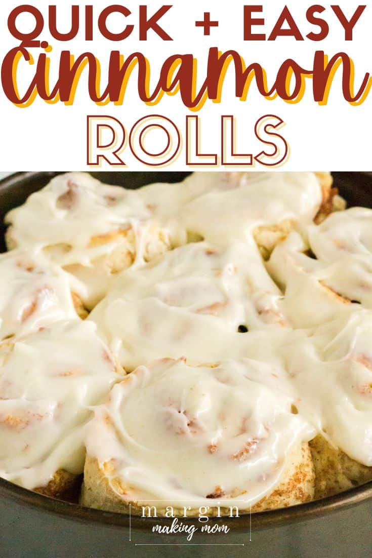 pan of cinnamon rolls with cream cheese frosting on top. 