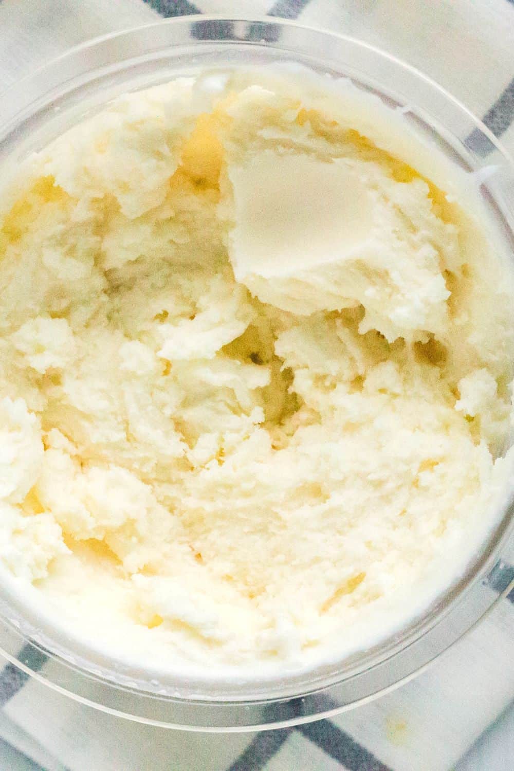 Overhead view of vanilla ice cream in a Ninja Creami pint.