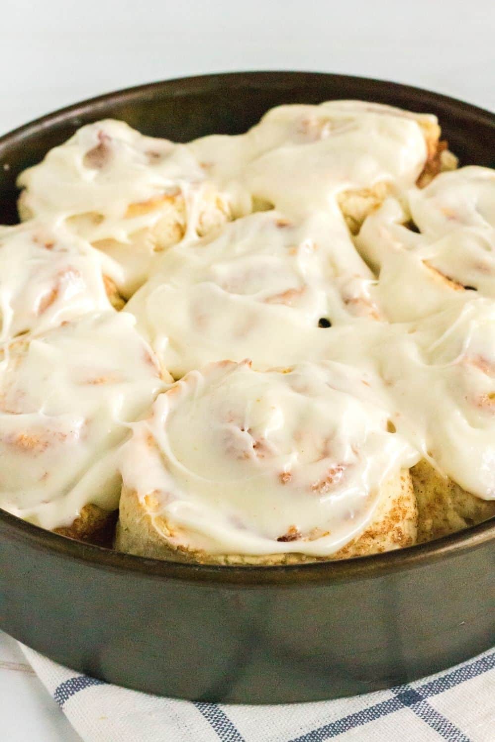 quick cinnamon rolls in the pan, topped with cream cheese frosting