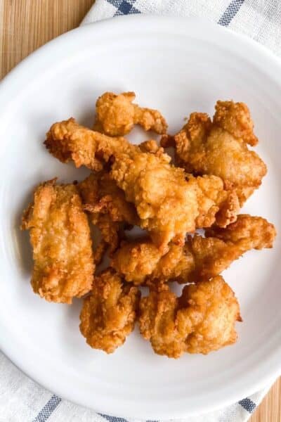 air fryer frozen chicken nuggets cooked and served on a white plate