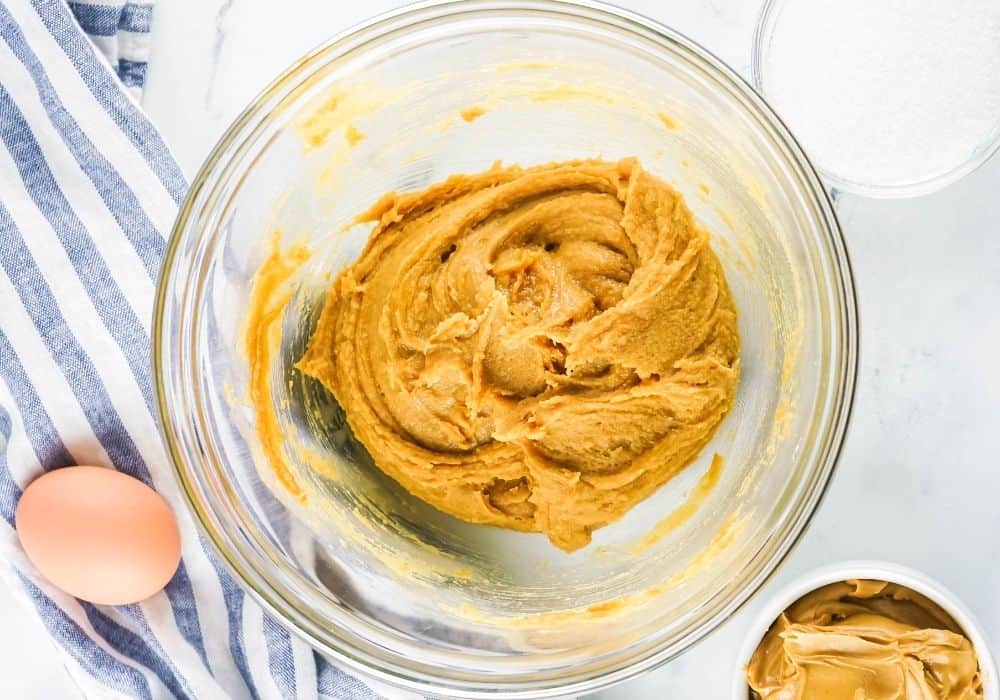 peanut butter cookie dough in a glass mixing bowl