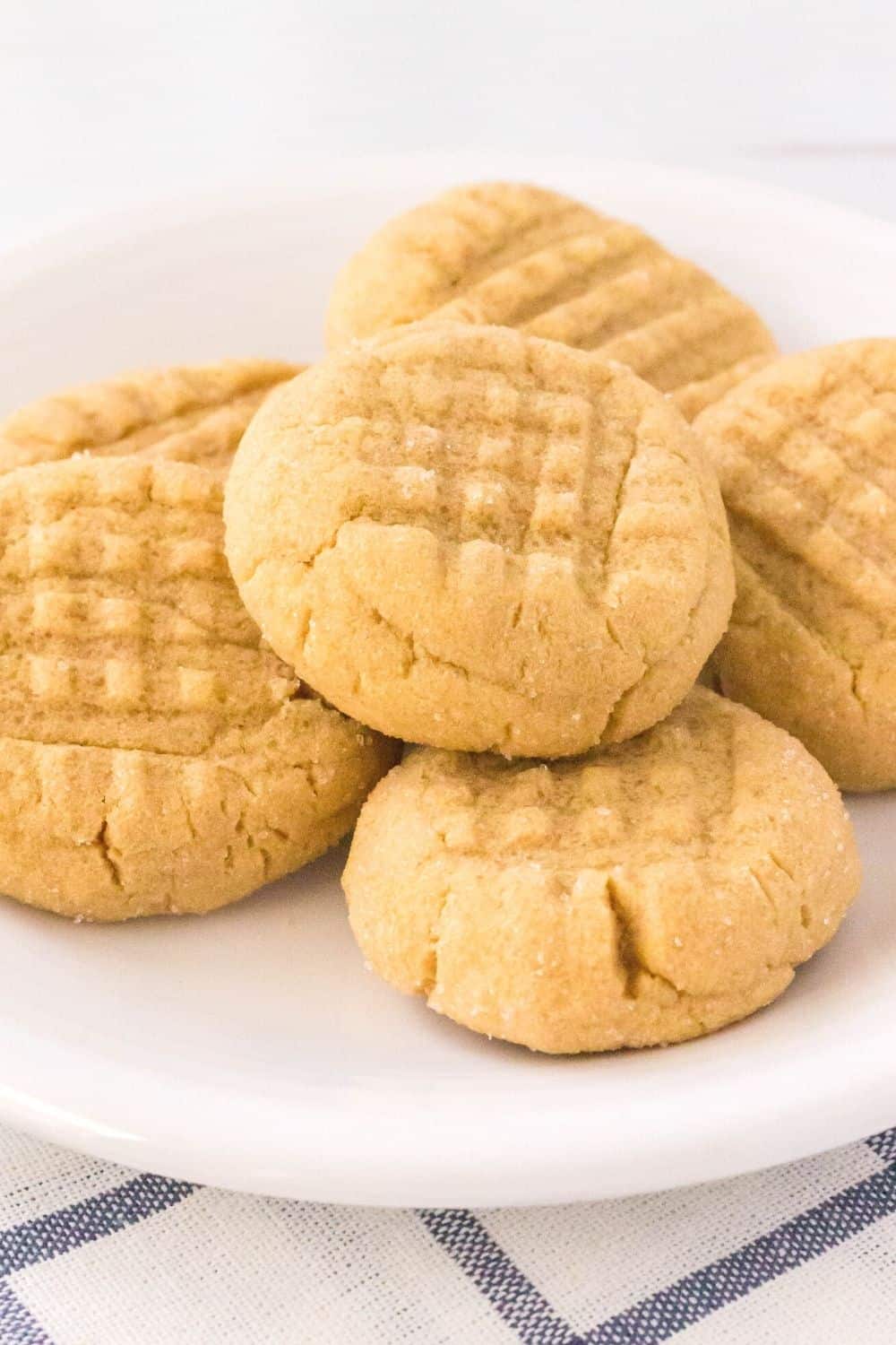 freshly baked soft and chewy peanut butter cookies on a white plate